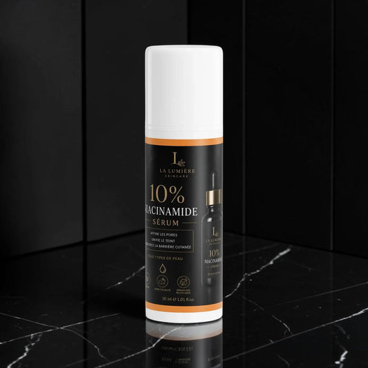 Sérum AlphaVIT 10% Niacinamide dans un flacon pompe noir et orange pour affiner les pores et unifier le teint.